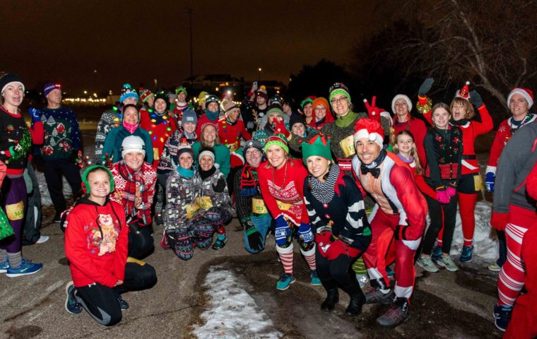 runners wearing ugly sweaters posing for a group photo