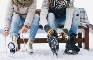 two people lacing their ice skates