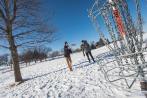 two people playing disc golf