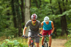 two men mountain biking on a trail