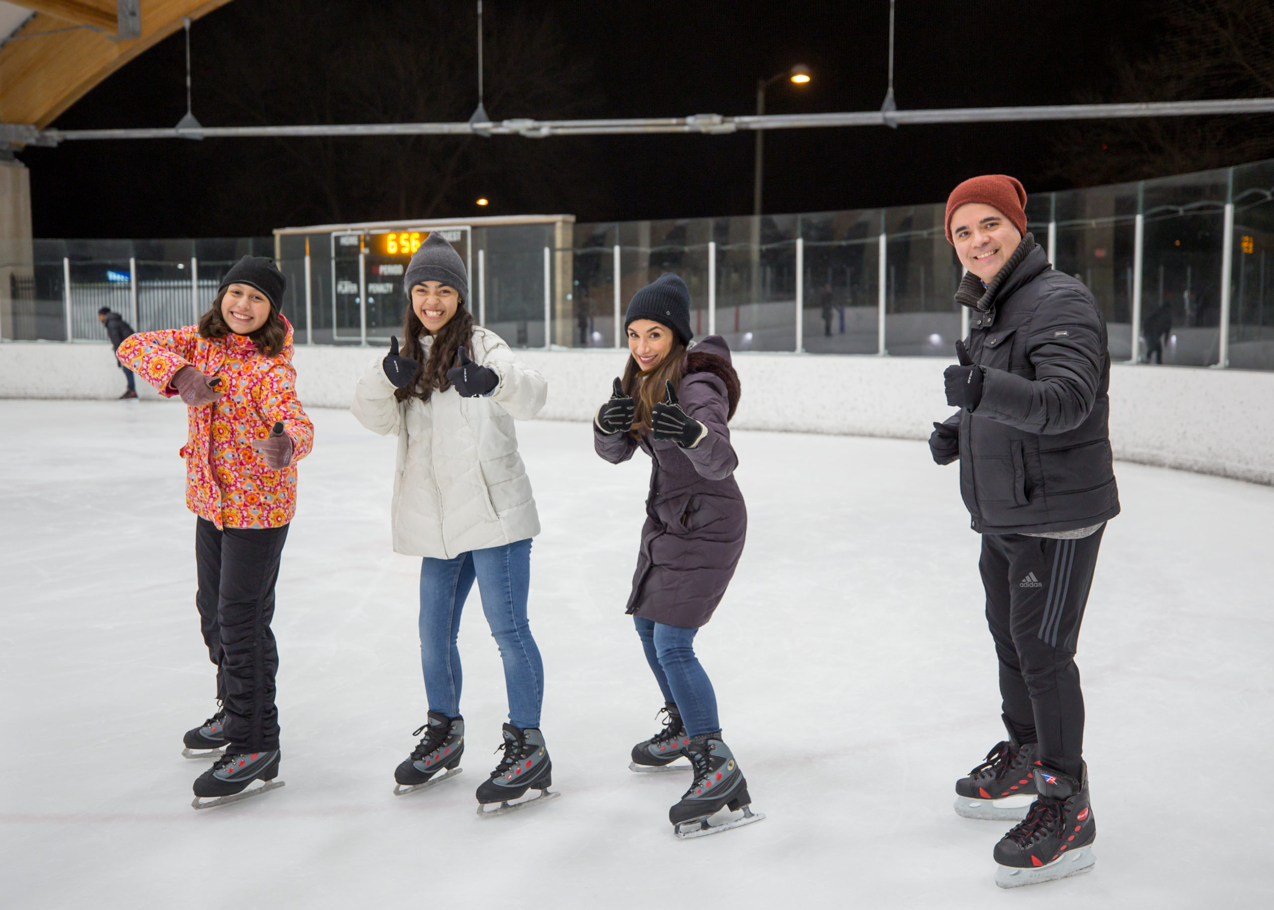 Family having fun on the ice at The Roc