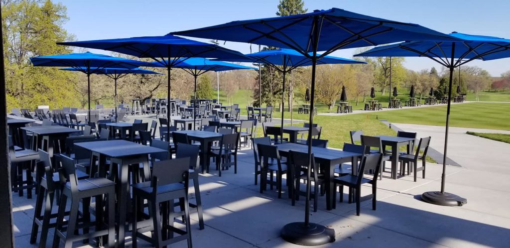 umbrella covered patio tables at the Three One Six Bar + Grill