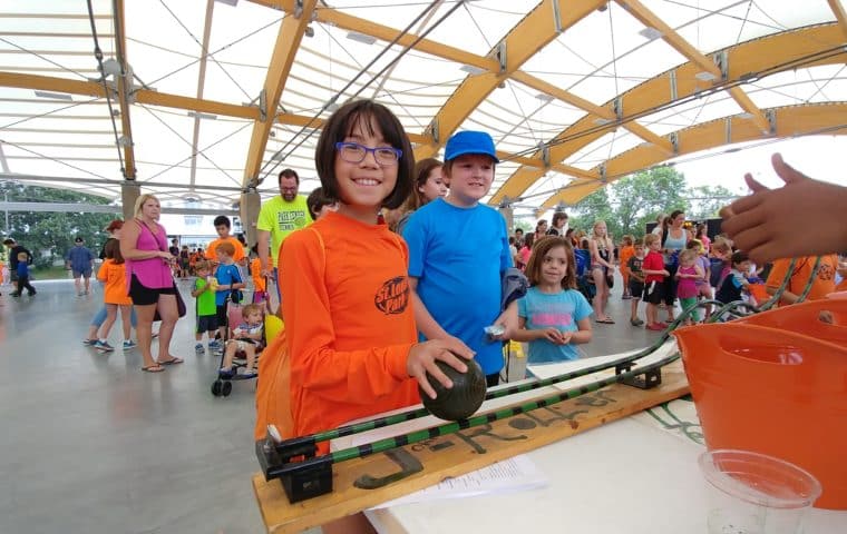 a girl playing a game at the penny carnival
