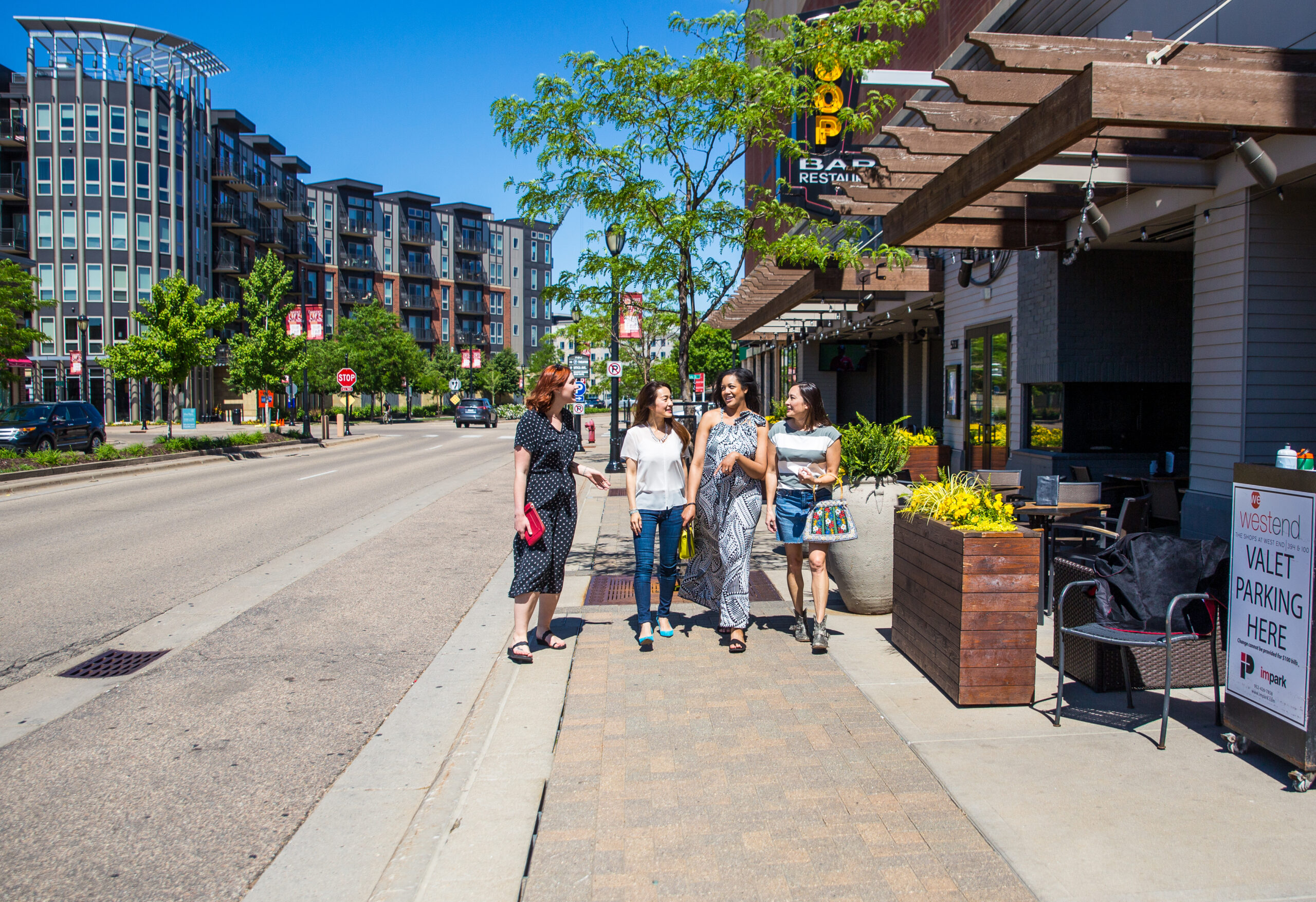 A group of women walking outside at The Shops at West End