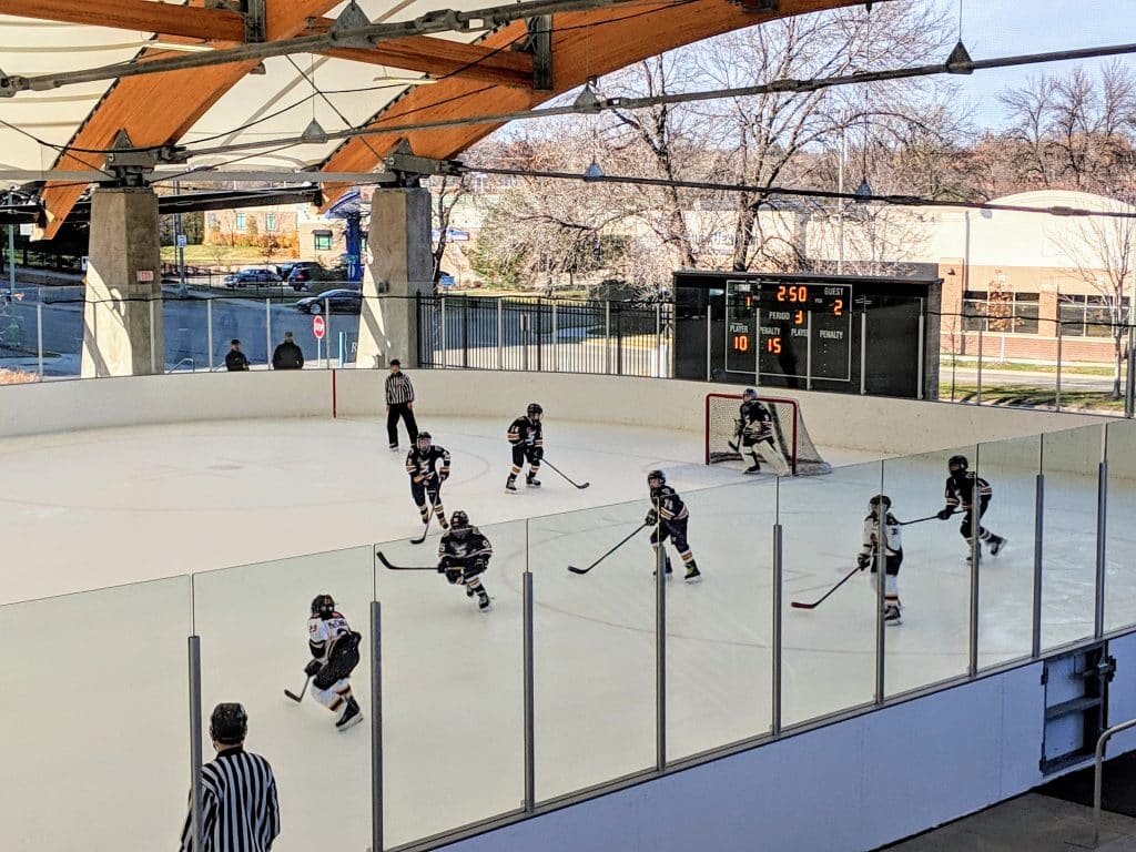 Hockey players skating on the ice during a game at The ROC in St. Louis Park