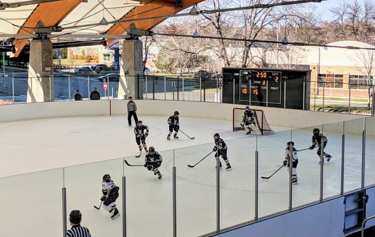 Hockey players skating on the ice during a game at The ROC in St. Louis Park