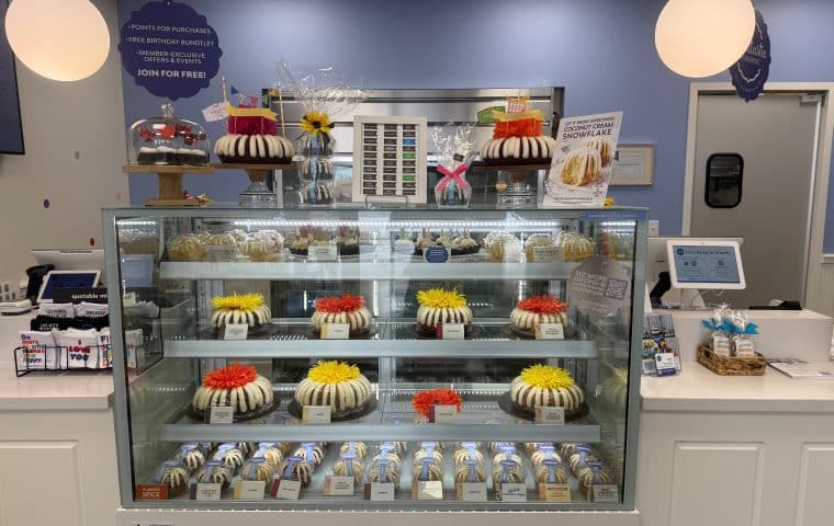 A bakery case filled with bundt cakes of various sizes and flavors at Nothing Bundt Cakes in St. Louis Park