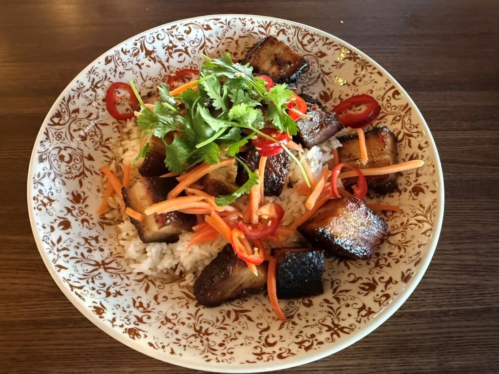 Vietnamese pork belly served on a bed of jasmine rice at Kitchen and Rail in Golden Valley
